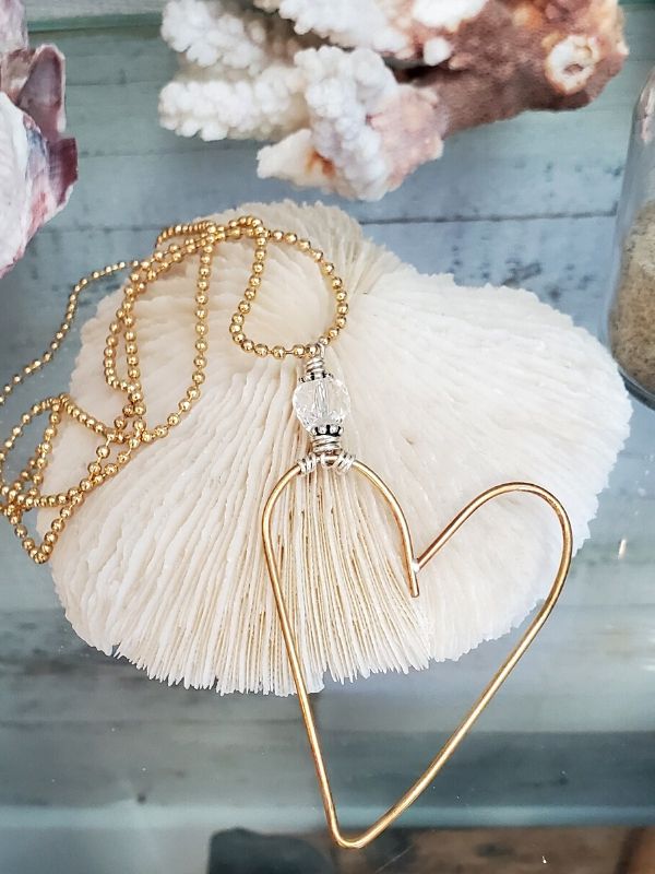 gold open heart necklace with beachy things